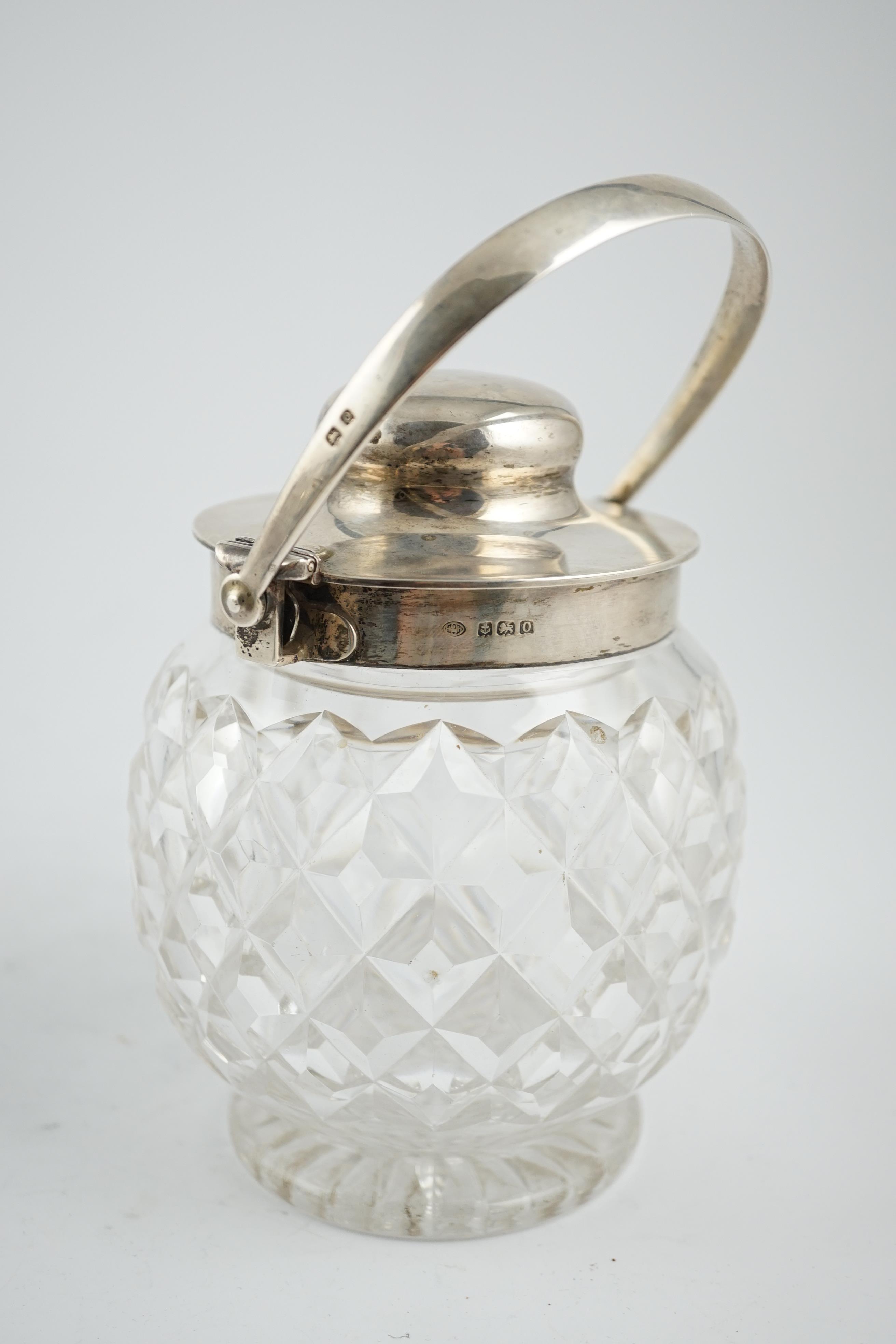 A George V silver mounted cut glass patent action biscuit barrel, by Hukin & Heath